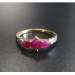 RUBY AND DIAMOND RING the central marquise cut ruby flanked by pear cut rubies and small diamonds,
