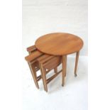 RETRO TEAK OCCASIONAL TABLE with a circular top, standing on turned tapering supports with