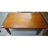 SIGNATURE TEAK OCCASIONAL TABLE with a rectangular moulded top above a narrow frieze, standing on