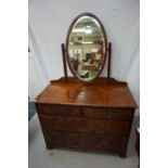 EDWARDIAN WALNUT AND FIGURED WALNUT DRESSING CHEST with a bevelled oval mirror back above two