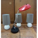 RED ANGLEPOISE DESK LAMP with weighted base and red shade along with three white globe table lamps
