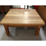 LIGHT OAK TABLE with a rectangular moulded top standing on bulbous supports cut down from original