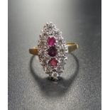 RUBY AND DIAMOND CLUSTER RING the three vertically set rubies in diamond surround, the diamonds