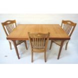 TEAK EXTENDING DINING TABLE the pull apart top revealing a fold out leaf, standing on turned