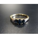 SAPPHIRE AND DIAMOND RING the three graduated oval cut sapphires flanked by small diamonds, on