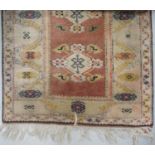 TABRIZ RUG with a central terracotta panel with four lozenge motifs, encased by geometric panels,
