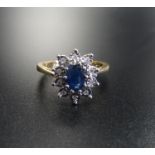 SAPPHIRE AND DIAMOND CLUSTER RING the central oval cut sapphire approximately 0.45cts in ten diamond