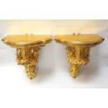 PAIR OF MID VICTORIAN CARVED GILTWOOD WALL BRACKETS of shaped outline, supported on carved