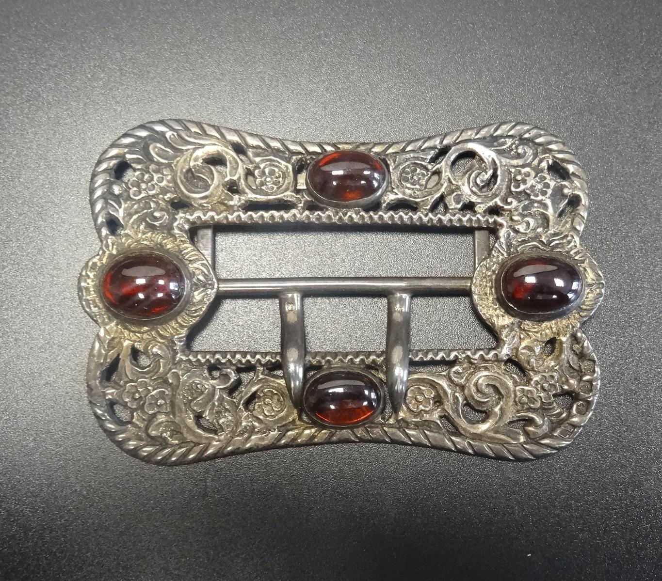 LATE VICTORIAN BELT BUCKLE with cabochon set stones to the decorative pierced and scrolled buckle,