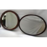 OVAL MAHOGANY WALL MIRROR with a bevelled plate, 52.5cm wide; a shaped teak wall mirror with pierced