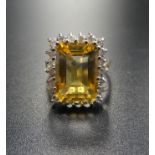 CITRINE AND DIAMOND COCKTAIL RING the large central emerald cut citrine in twenty-two diamond