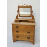 EDWARDIAN LIGHT OAK DRESSING CHEST with a shaped adjustable bevelled mirror back above two jewellery