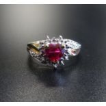 SYNTHETIC RUBY AND DIAMOND CLUSTER DRESS RING the central heart cut ruby in textured surround set