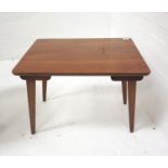 RETRO WALNUT OCCASIONAL TABLE with an oblong moulded top standing on tapering folding supports,