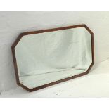 OCTAGONAL SHAPED WALL MIRROR with a walnut frame and a bevelled plate, 70.5cm wide