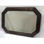 1920s OAK OCTAGONAL FRAME WALL MIRROR with bevelled plate, the frame with raised detail, 54cm high x