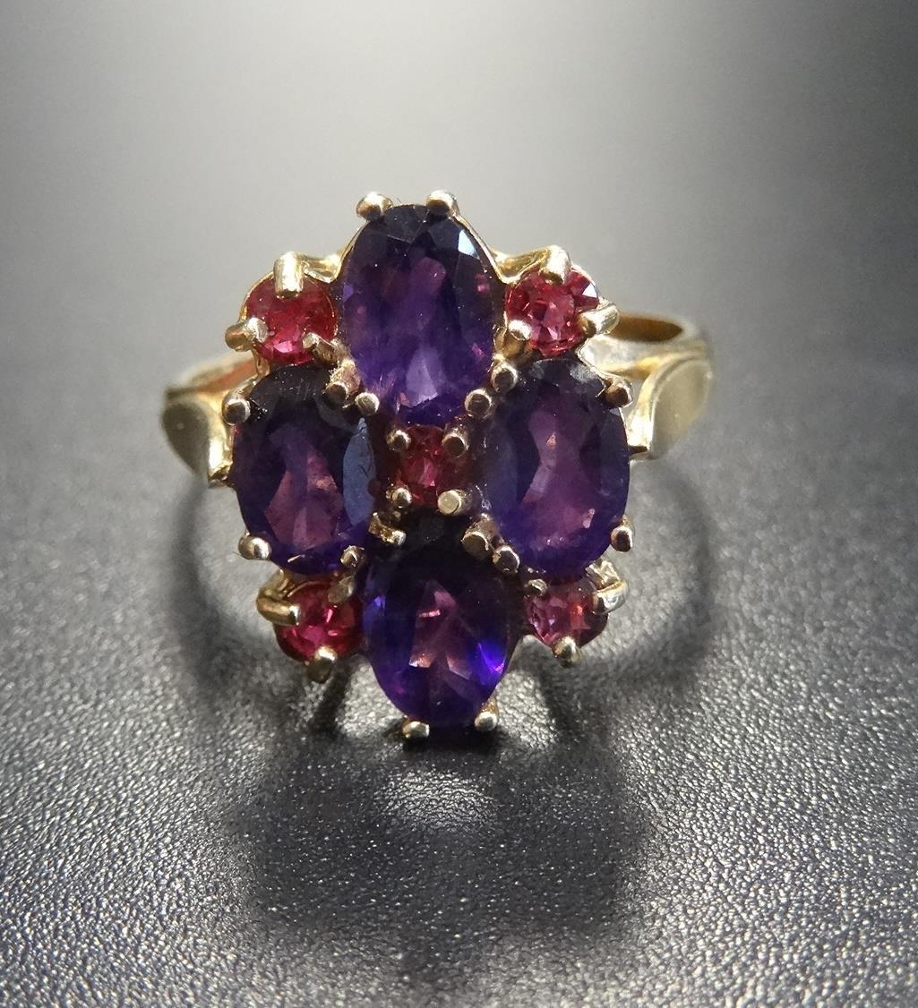 RUBY AND AMETHYST DRESS RING the four oval amethysts separated by small rubies, on nine carat gold