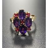 RUBY AND AMETHYST DRESS RING the four oval amethysts separated by small rubies, on nine carat gold