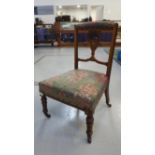 EDWARDIAN INLAID WALNUT NURSING CHAIR with carved and shaped detail to backrest, fabric covered