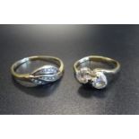 TWO CZ SET GOLD RINGS one a two stone twist design ring on nine carat gold shank, the other in