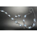 MOONSTONE SET SILVER SUITE OF JEWELLERY the oval cabochon moonstones in pierced and shaped links,