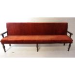 LARGE OAK FRAME BENCH early 20th century, with a padded back and seat, covered in a terracotta