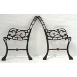 PAIR OF CAST IRON BENCH ENDS each with scroll shaped arms, standing on shaped supports, 67.5cm high