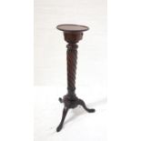 19th CENTURY MAHOGANY TORCHERE with circular top, twist column, and raised on tripod legs, 95cm high