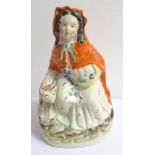 VICTORIAN STAFFORDSHIRE FIGURE OF 'LITTLE RED RIDING HOOD' the seated figure holding a basket in her