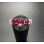 RUBY AND DIAMOND RING the four oval cut rubies flanked by four small diamonds to each shoulder, on