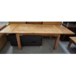 TEAK EXTENDING DINING TABLE with a draw leaf plank top standing on plain supports, 240cm extended,