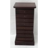 NARROW TEAK CHEST with a moulded top above eight drawers with ring pull handles, standing on a
