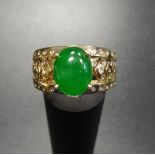 UNUSUAL JADE AND DIAMOND DRESS RING the central oval jade cabochon flanked by diamond set chevron