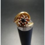 GARNET CLUSTER RING on nine carat gold shank with twist setting, ring size L-M