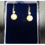 PAIR OF DIAMOND AND SIMULATED PEARL EARRINGS in fourteen carat gold