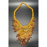 MODERN AMBER BEAD NECKLACE the varying shades of amber in graduated fringed front piece,