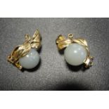 PAIR OF JADE SET EARRINGS the jade ball on each within fourteen carat gold setting in the form of