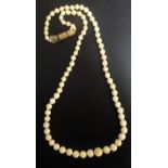 GRADUATED IVORY BEAD NECKLACE individually knotted and with attractive floral and scroll engraved