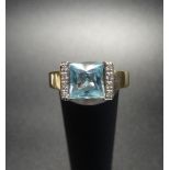 AQUAMARINE AND DIAMOND DRESS RING the princess cut aquamarine flanked by a vertical row of