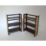 PAIR OF FOLDING AND STACKING SHELVES each with a pair of fold out caned sides, each with three