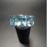 AQUAMARINE THREE STONE RING the three oval cut aquamarines on nine carat gold shank, ring size P