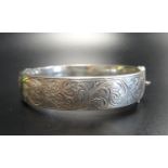 ENGRAVED SILVER BANGLE the hinged bangle with scroll decoration to one side, Birmingham hallmarks