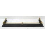 EDWARDIAN BRASS AND CAST IRON FIRE CURB the cast iron base with raised floral motifs, 135cm long x