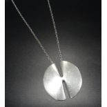 1970s GEORG JENSEN SILVER PENDANT ON CHAIN to a design by Nanna Ditzel, the circular pendant with