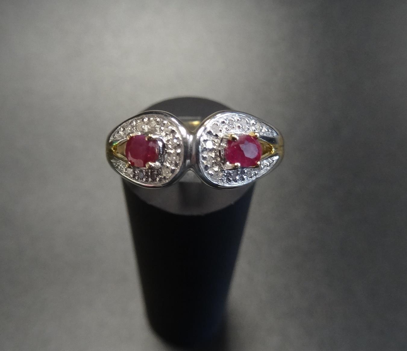 RUBY AND DIAMOND CLUSTER RING each of the two rubies in diamond surround, on nine carat gold