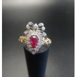 UNUSUAL RUBY AND DIAMOND CLUSTER RING the pear cut ruby in diamond surround and surmounted by a