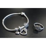 PANDORA MOMENTS SILVER CHARM BRACELET with three Pandora charms; together with a Pandora Sparkling