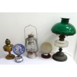 EDWARDIAN OIL LAMP raised on a circular embossed base to a glass reservoir, stack and green glass