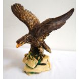 RESIN MODEL OF A GOLDEN EAGLE with it's wings out stretched, on a naturalistic base, 33cm high