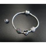 PANDORA MOMENTS HEART CLASP SILVER CHARM BRACELET with three Pandora charms and one Pandora